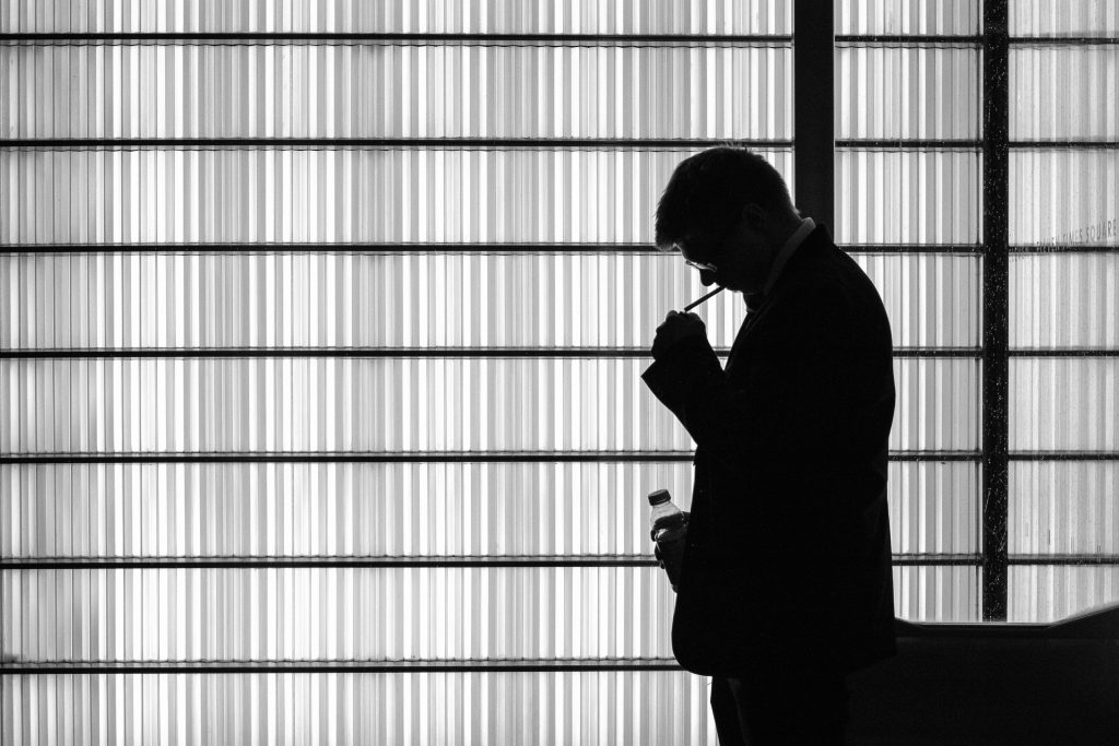 Thoughtful professional by a window representing curiosity and strategic thinking